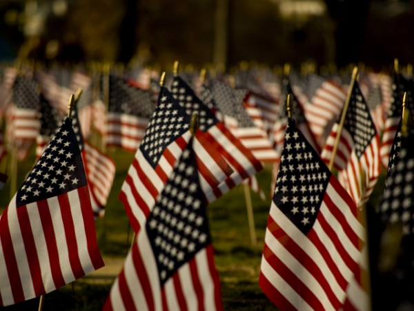 When an American flag touches the ground, what is the proper thing to do with it?