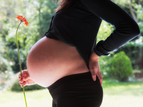 There's a pregnant woman nearing a door you're about to go through. Do you hold it for her even if it means waiting?