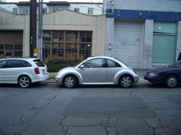 While parallel parking, you accidentally scrape the car in front of you. How do you handle the situation?