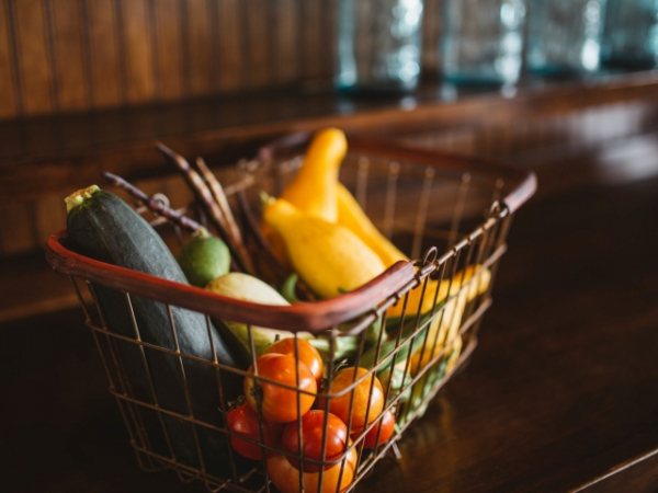 An elderly woman is having a difficult time carrying her groceries. Do you help her out?